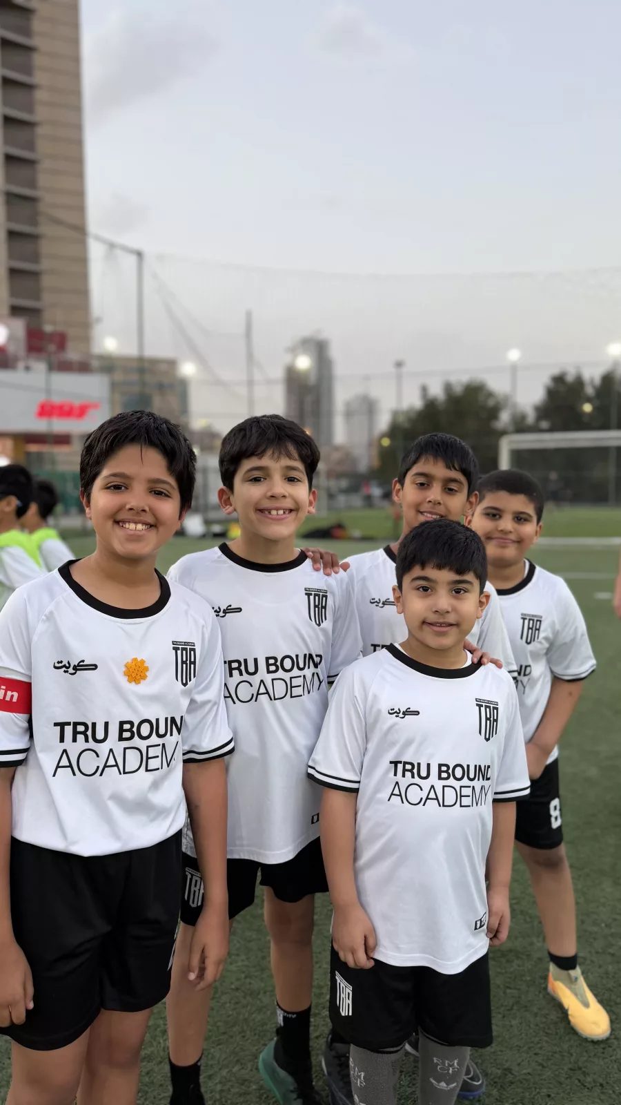 Group of young academy players gathered on the pitch